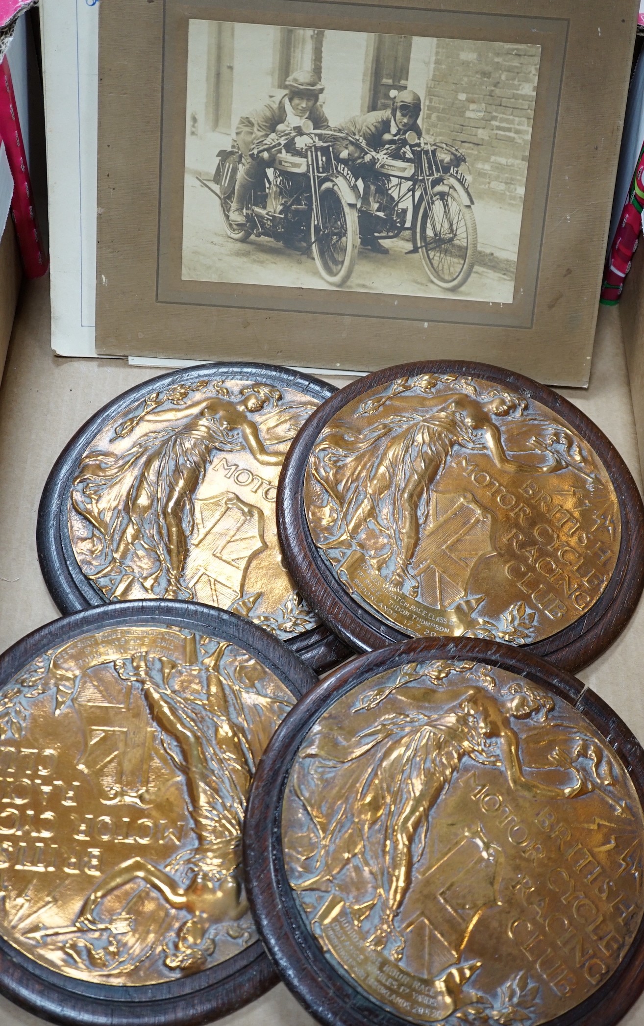 Four circular bronze British Motorcycle Racing Club plaques and related material